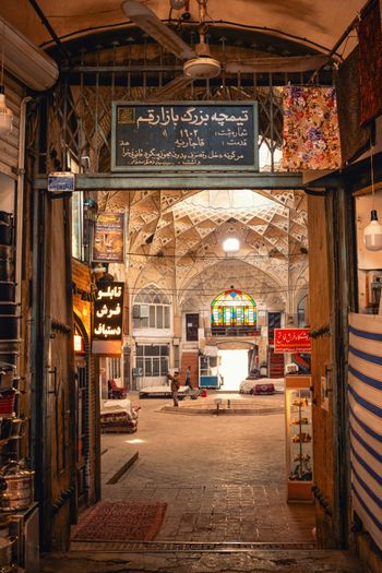 a building with a large arched doorway and a sign above it