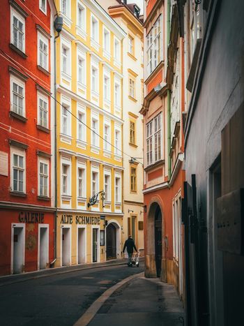 a narrow street in a european city with tall buildings