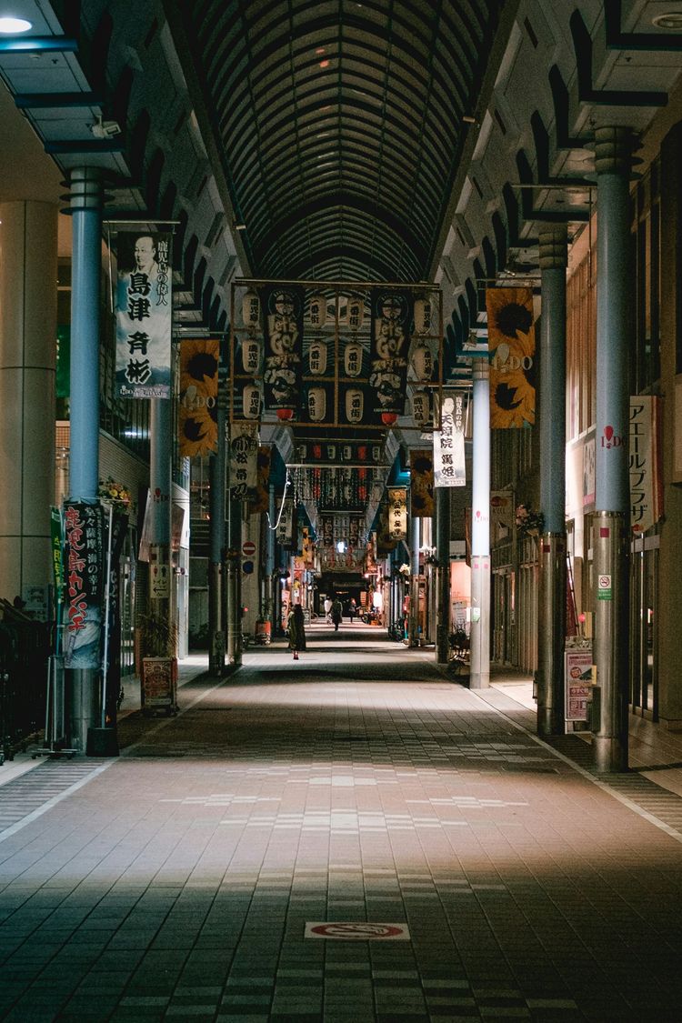 people walking on sidewalk during nighttime