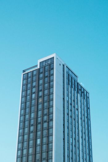 a very tall building with a sky background
