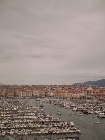 A harbor filled with lots of boats under a cloudy sky