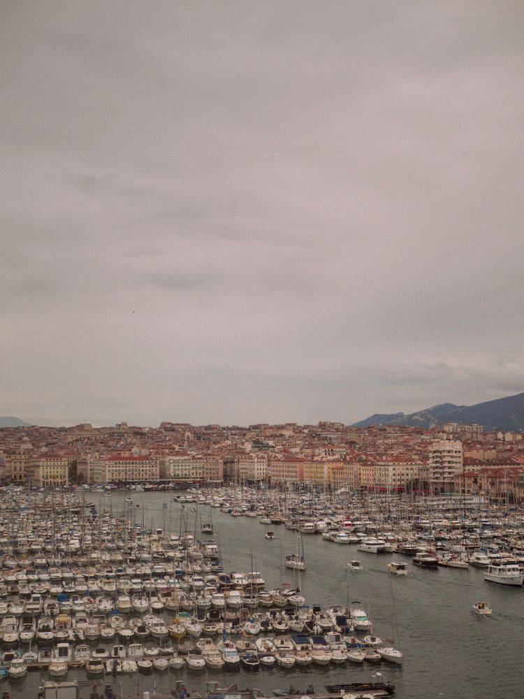 A harbor filled with lots of boats under a cloudy sky