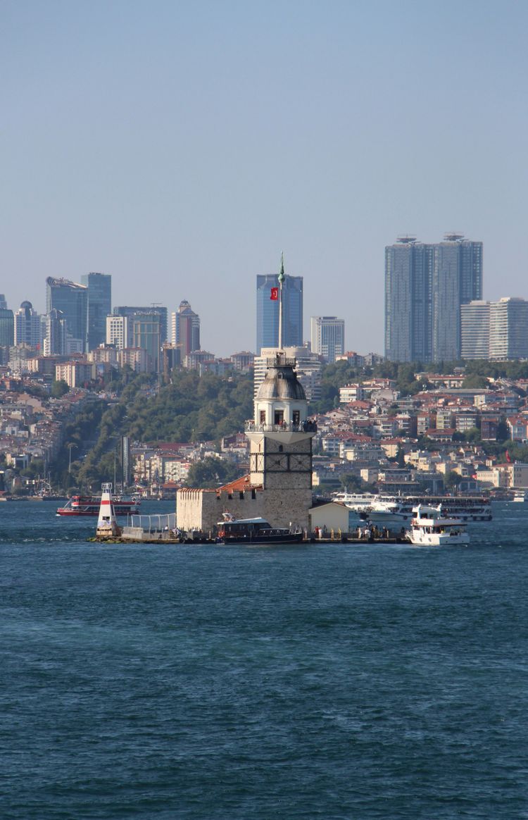 a large body of water with a city in the background