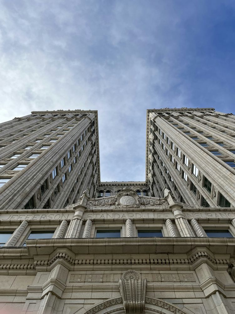 looking up at two tall buildings in a city