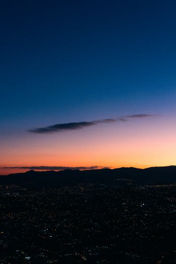 a view of a city at sunset from a plane