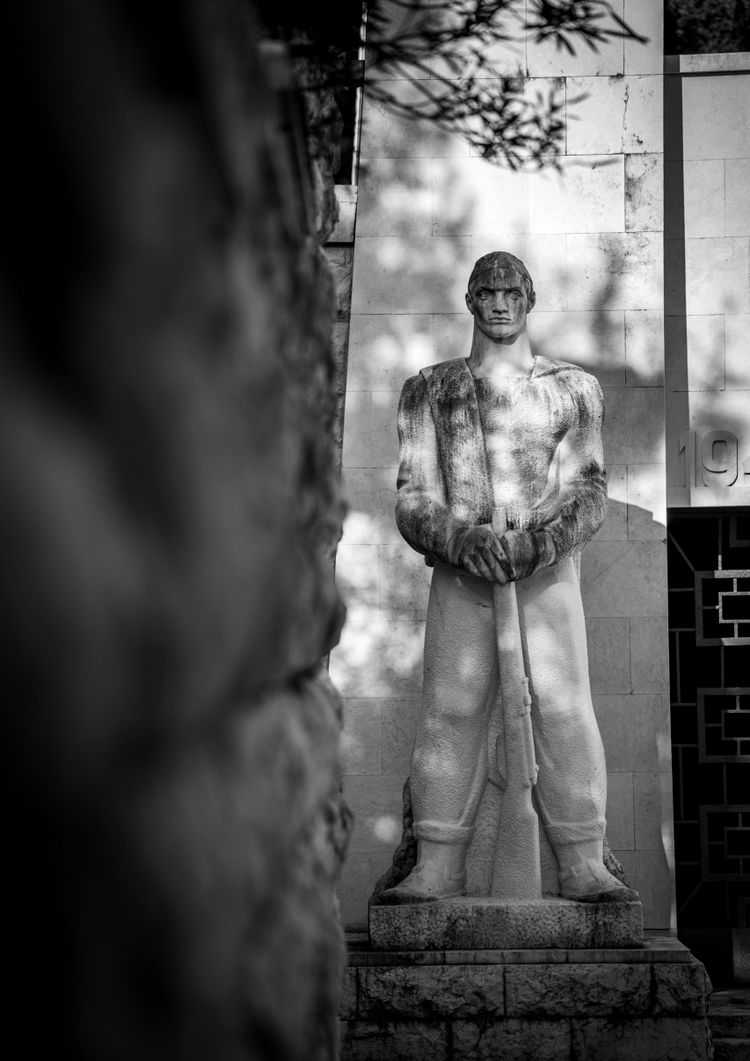 A black and white photo of a statue of a man