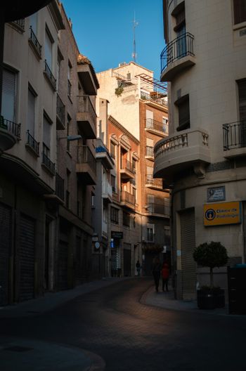 a city street with people walking down it