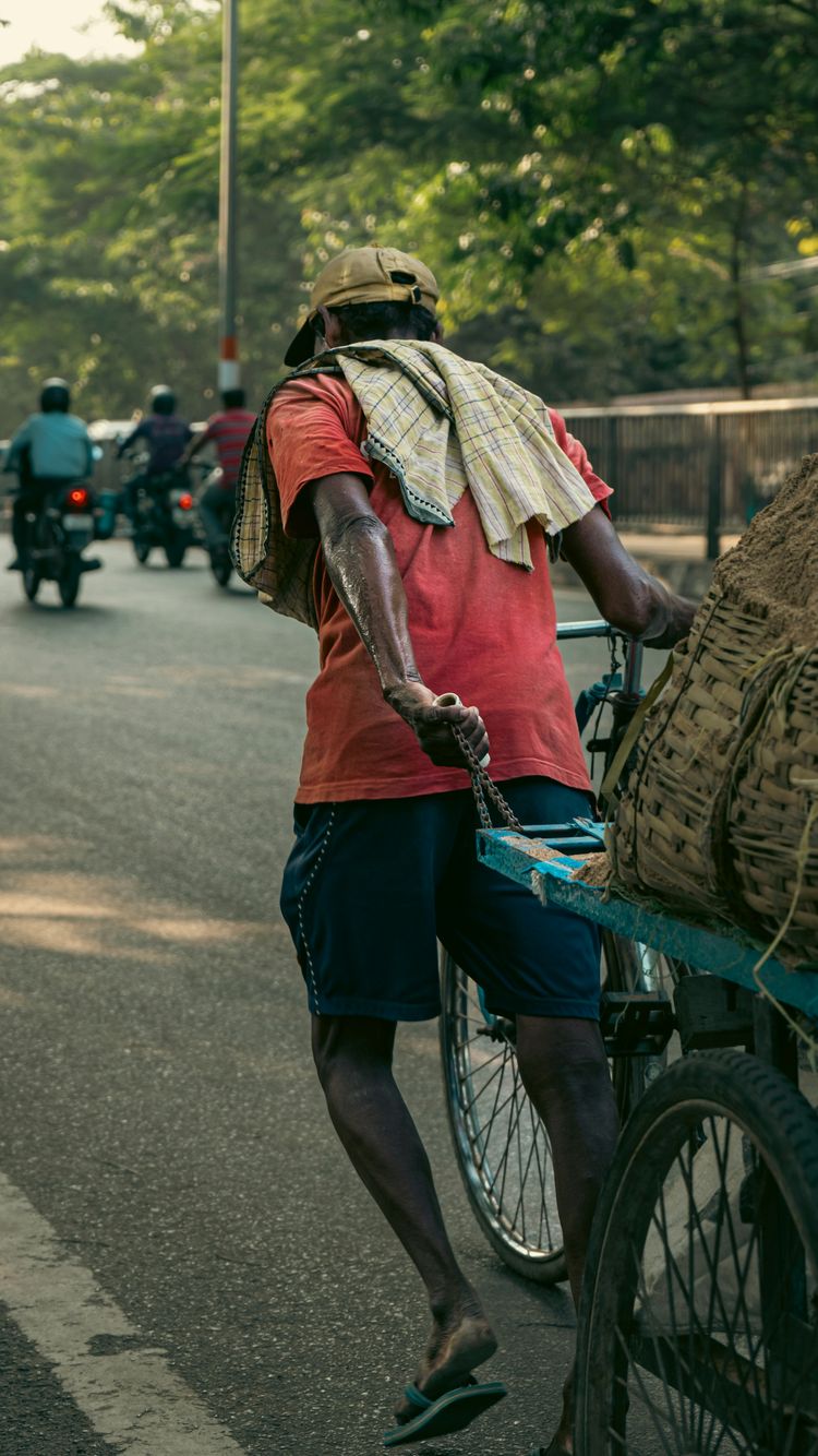 a man riding a bike with a basket on the back of it