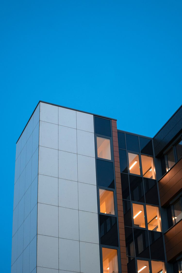 a tall white building with lots of windows