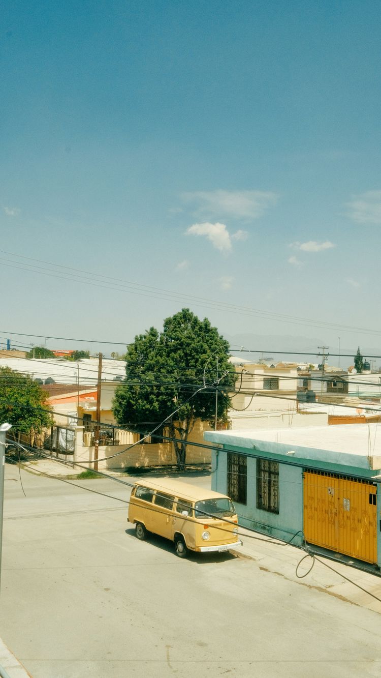 a yellow van parked in front of a building