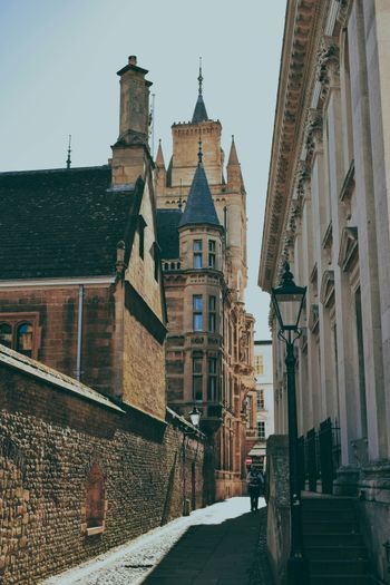 A narrow city street with tall buildings on both sides