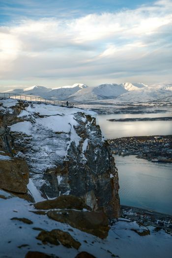 a man standing on top of a snow covered mountain