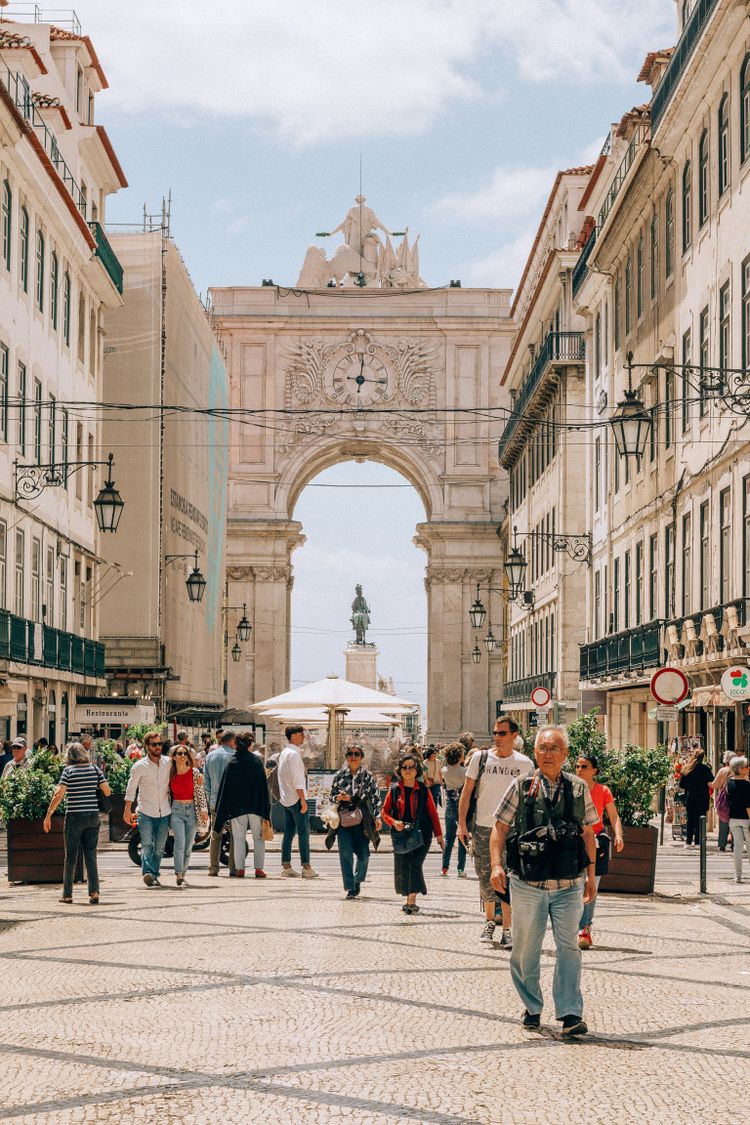 people walking on street near white concrete building during daytime