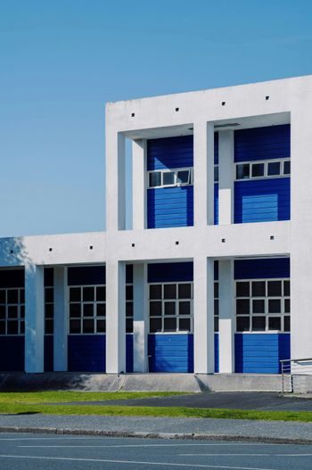 a large white building with blue doors and windows
