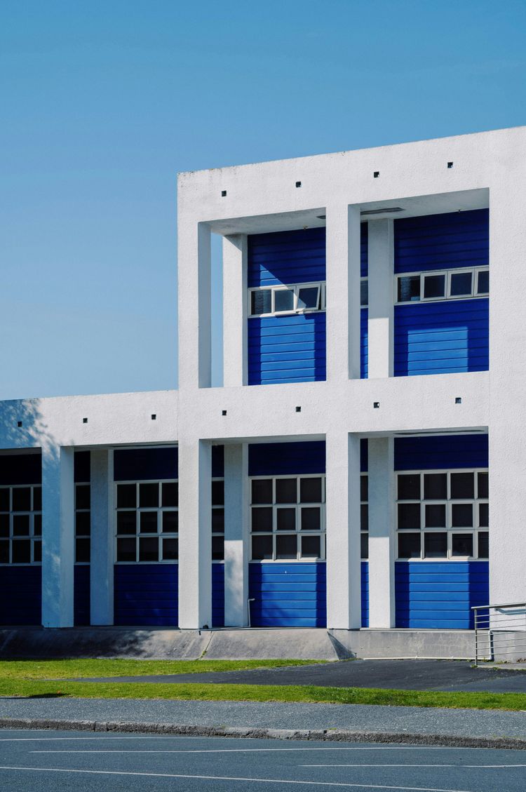 a large white building with blue doors and windows
