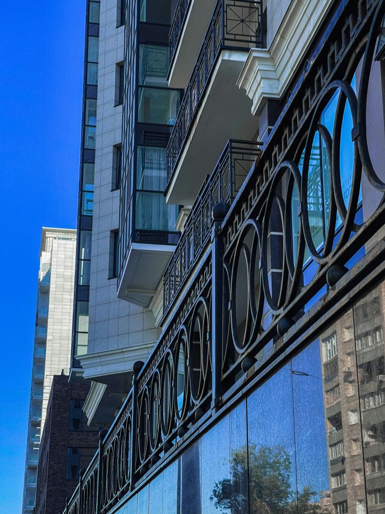 a reflection of a building in the glass of another building