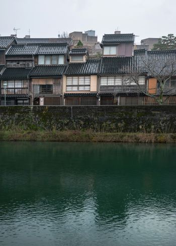 A body of water in front of a row of buildings