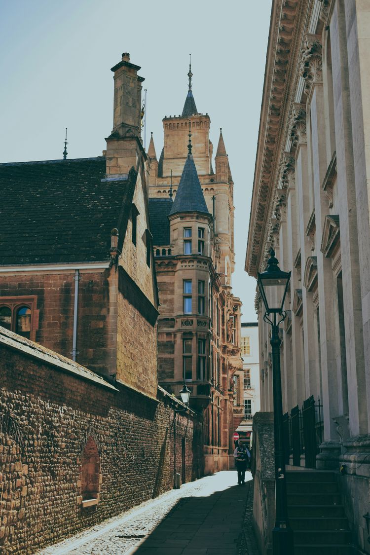 A narrow city street with tall buildings on both sides