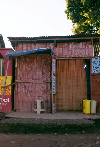 a small red building with a blue roof