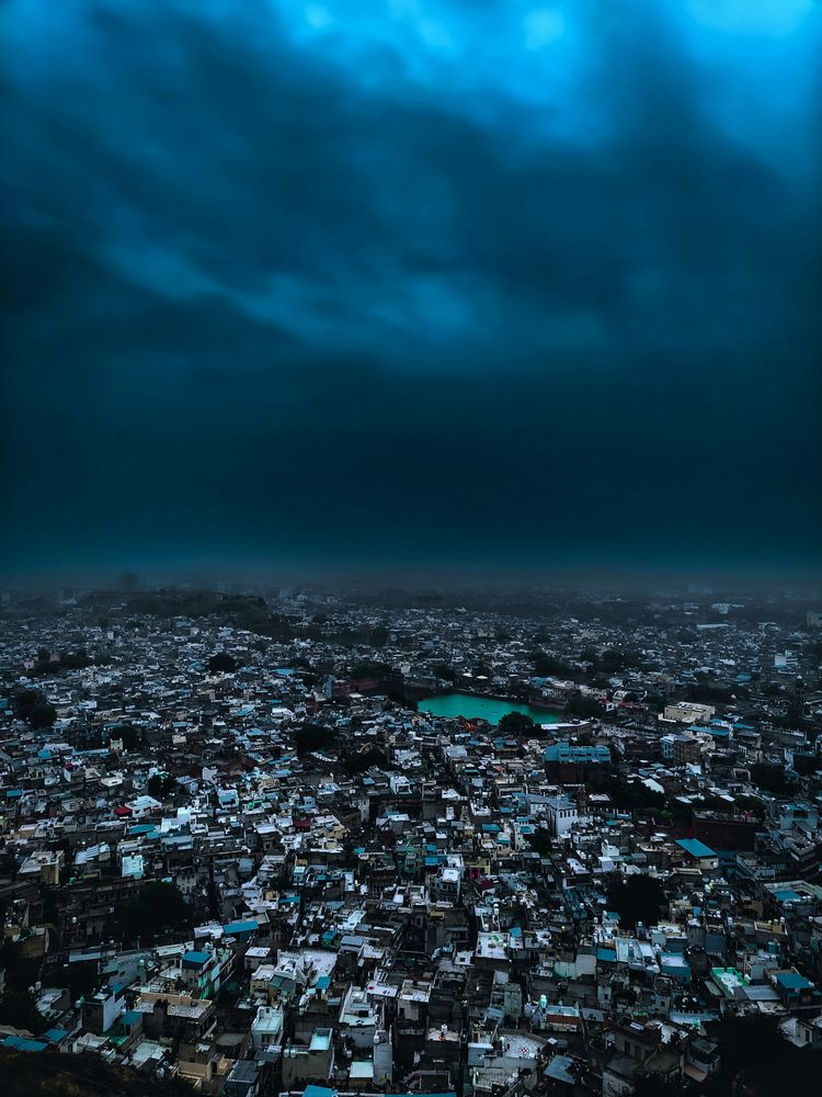 An aerial view of a city under a cloudy sky