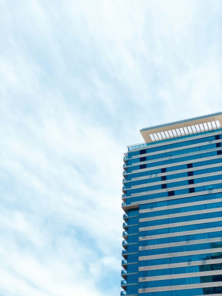 a very tall building with a sky background