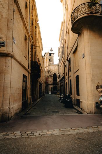 A narrow city street with a balcony and balconies