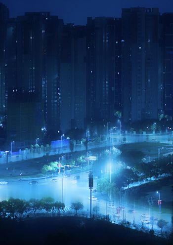 a night scene of a city with a river running through it