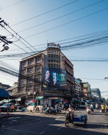 a busy city street with a large building on the corner