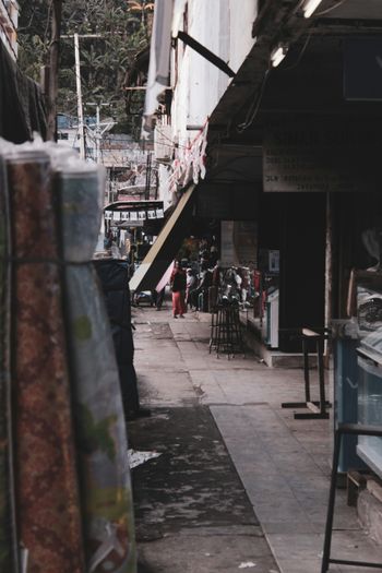 a narrow street with a bunch of furniture on the side of it