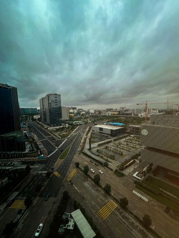 an aerial view of a city with a cloudy sky