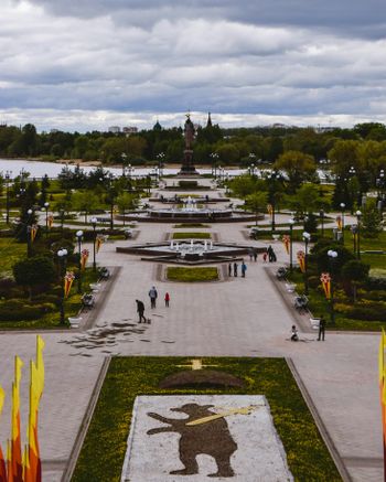 a view of a park with people walking around