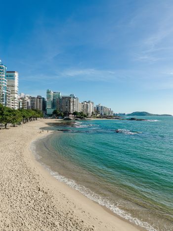 a beach with a city in the background