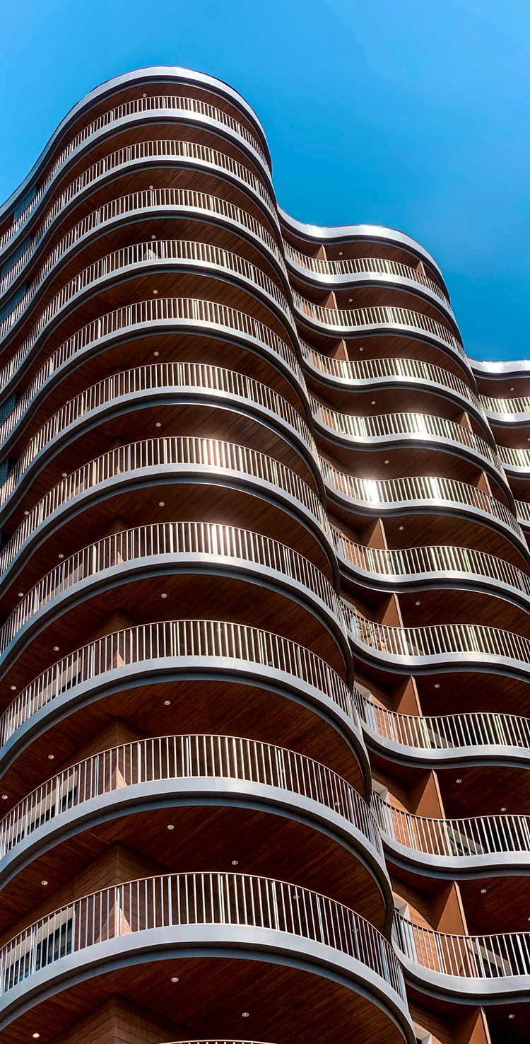 a tall building with balconies on the top of it