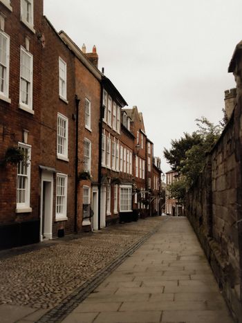 a cobblestone street lined with brick buildings