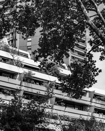 a black and white photo of a building with balconies