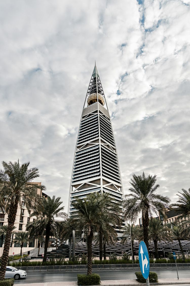 a tall building with trees in front of it