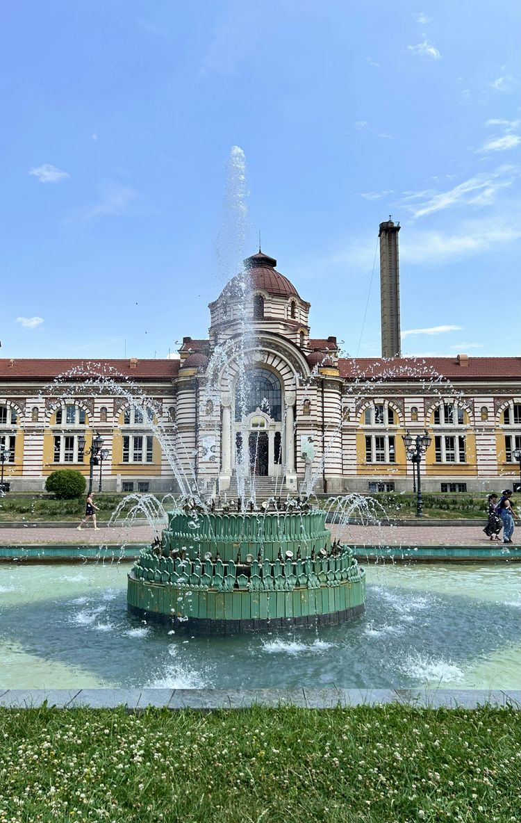 A large building with a fountain in front of it