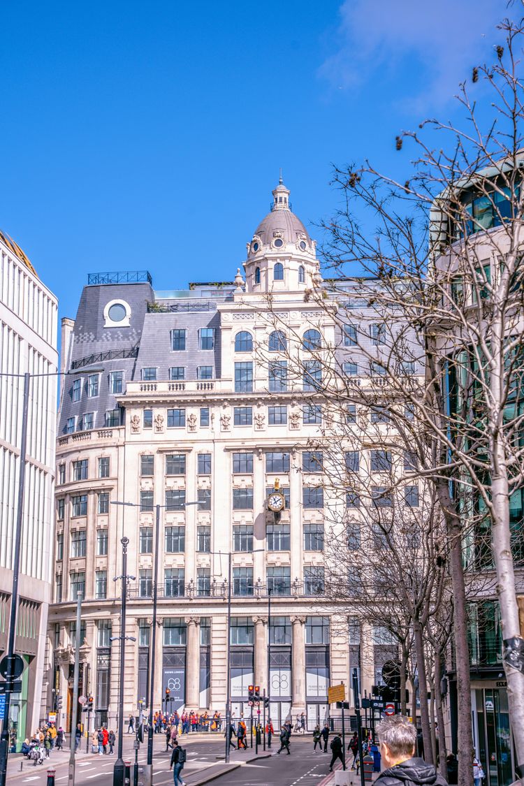 a large white building with a clock on the top of it