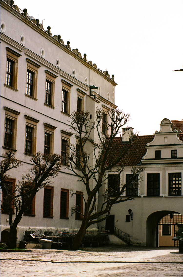 a clock on a pole in front of a building