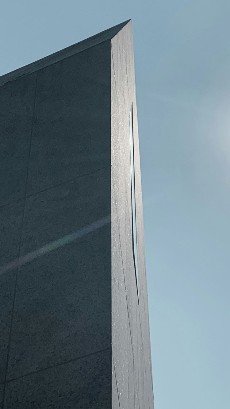 gray concrete wall under blue sky during daytime