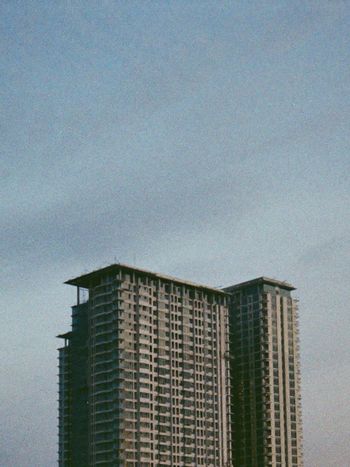 white and brown concrete building under white sky during daytime