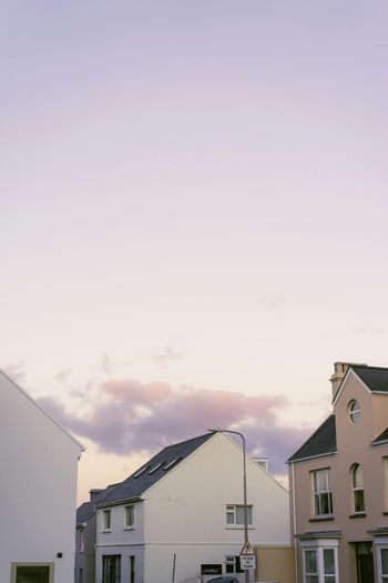 a group of buildings with a cloudy sky above