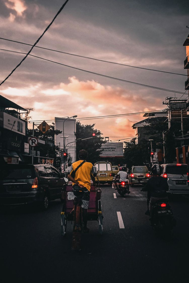 vehicles passing on road during golden hour