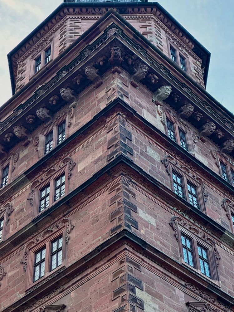 a tall brick building with a clock on the top of it