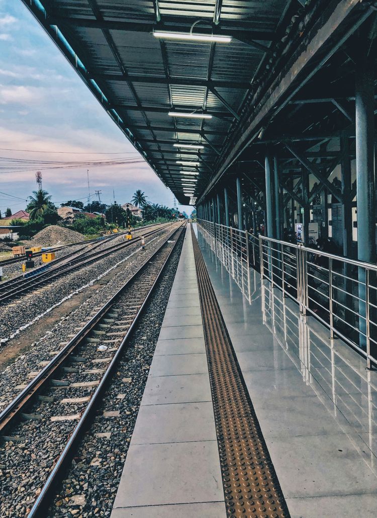 a train station with a train on the tracks