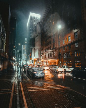 vehicles parked on road at night