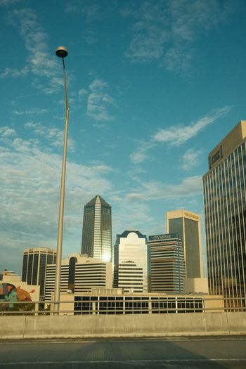 a city skyline with tall buildings and a street light