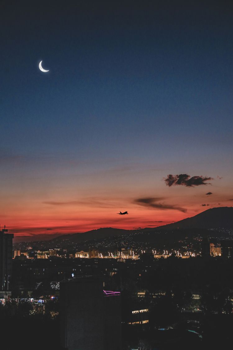 a moon in the sky over a city