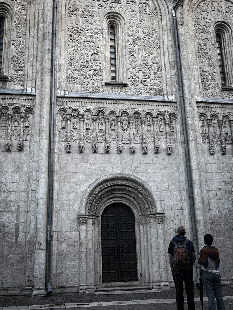 Two people standing in front of a large building