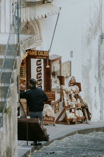 a man standing next to a pile of furniture